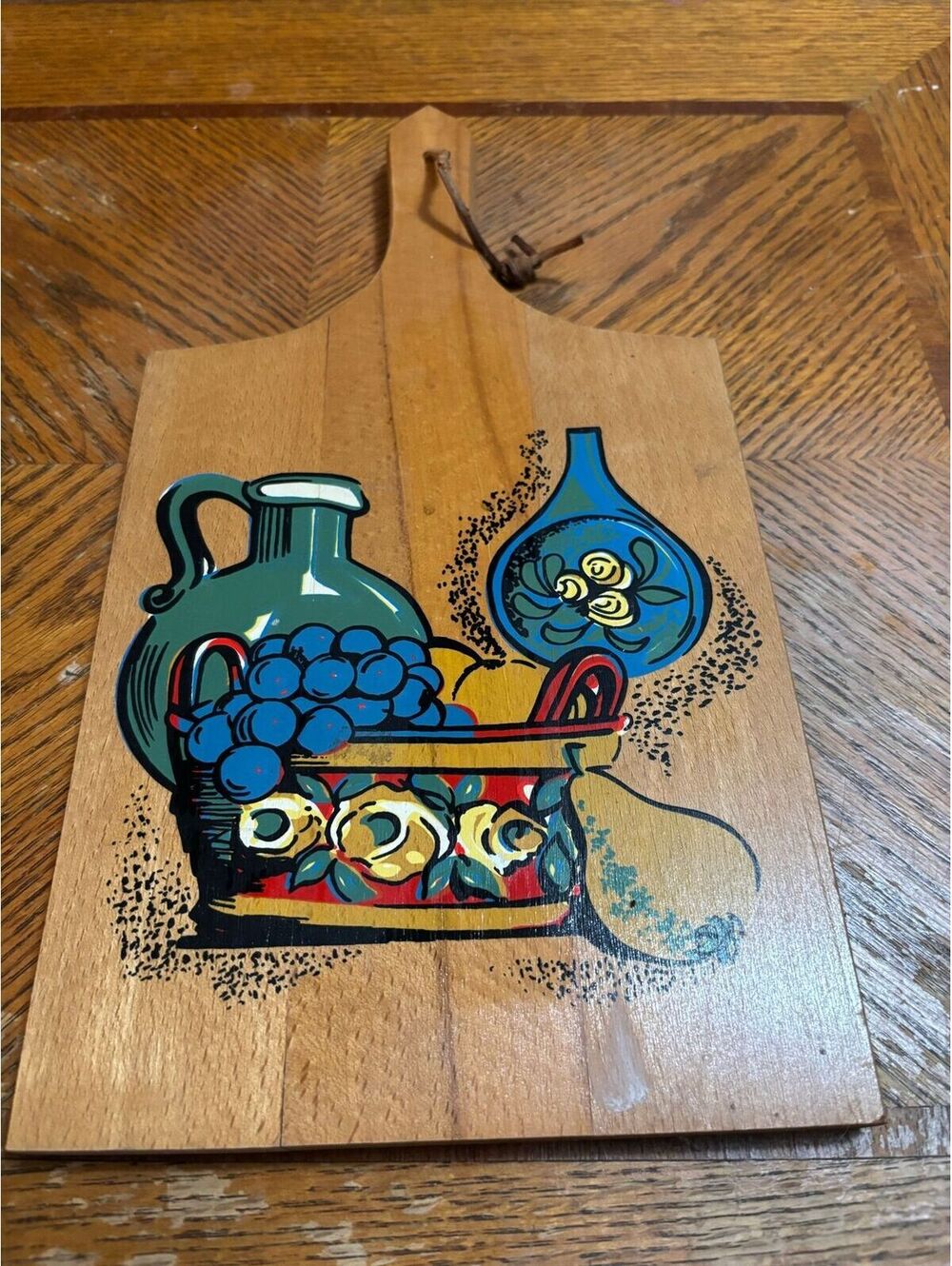 vintage hand-painted wooden cutting board with a colorful fruit pattern.